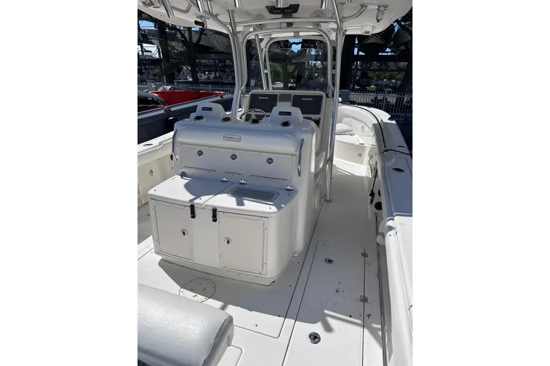 Slide: The Image of 2011 Robalo R300 Center Console boat interior with seating and storage compartments. - 10