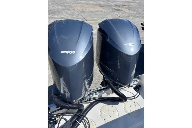 Slide: The Image of Twin outboard engines on a 2011 Robalo R300 Center Console boat. - 11
