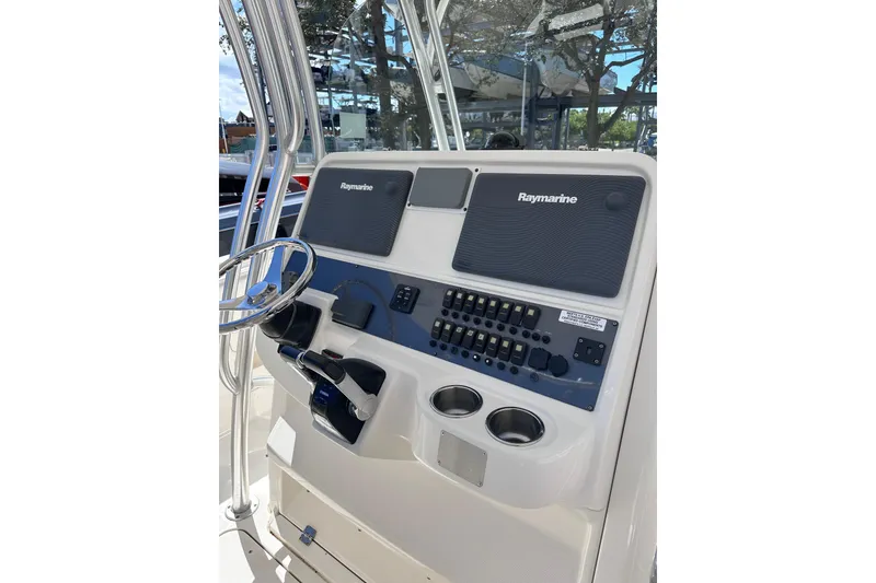 Slide: The Image of 2011 Robalo R300 Center Console helm with Raymarine electronics and dual cup holders. - 13
