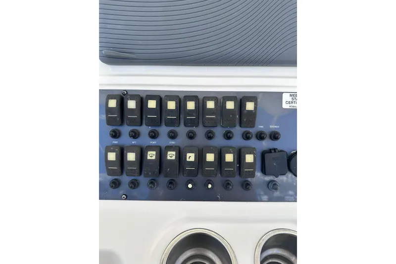 Slide: The Image of Control panel of 2011 Robalo R300 Center Console boat with switches and dials. - 14