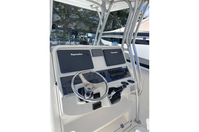 Slide: The Image of 2011 Robalo R300 Center Console helm with Raymarine electronics and stainless steel steering wheel. - 20