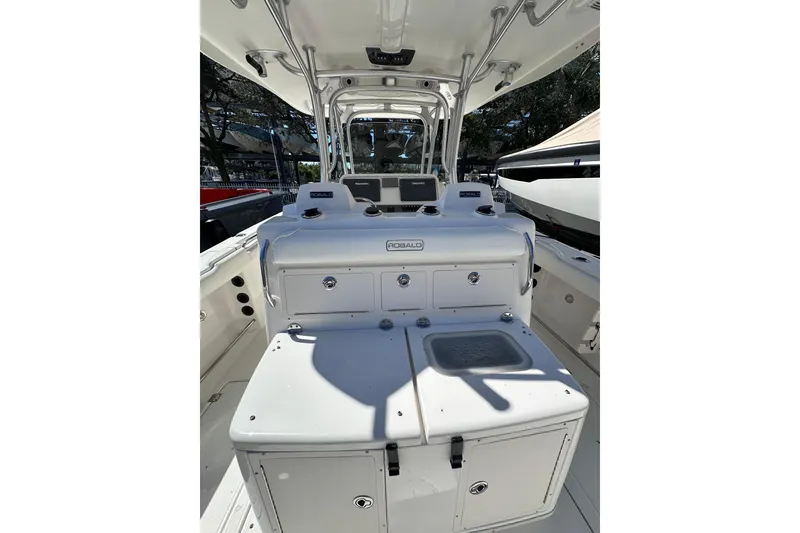 Slide: The Image of 2011 Robalo R300 Center Console boat interior with storage compartments and control panel. - 22
