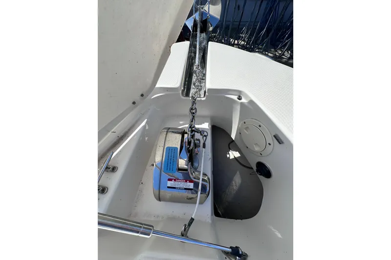 Slide: The Image of 2011 Robalo R300 Center Console anchor compartment with chain and winch. - 27