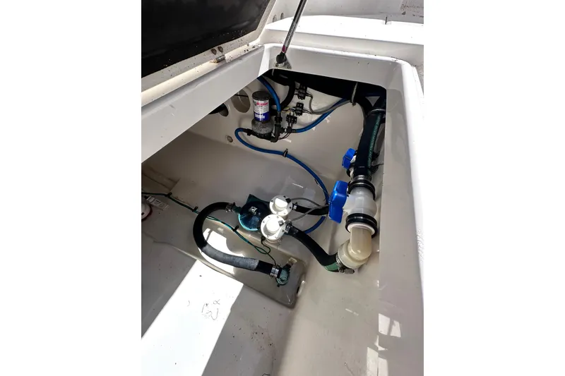 Slide: The Image of 2011 Robalo R300 Center Console boat interior with visible plumbing and wiring components. - 32