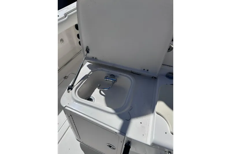 Slide: The Image of 2011 Robalo R300 Center Console boat sink with open lid and faucet. - 34
