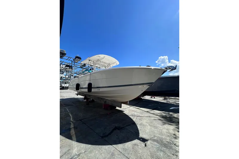 Slide: The Image of 2011 Robalo R300 Center Console boat on dry dock under clear blue sky. - 4