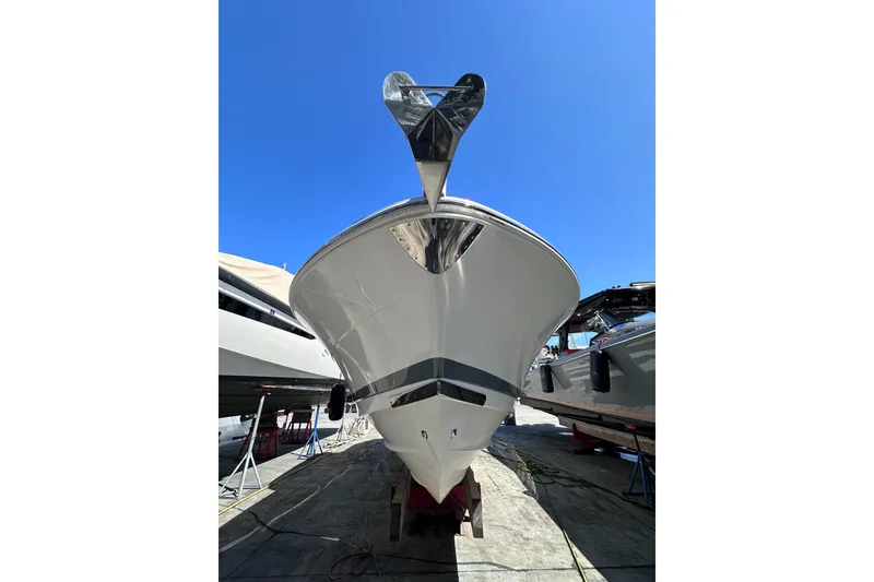 Slide: The Image of 2011 Robalo R300 Center Console boat on dry dock under clear blue sky. - 5