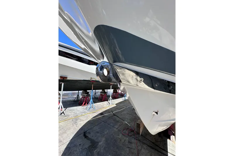 Slide: The Image of 2011 Robalo R300 Center Console boat hull on stands, close-up view. - 6
