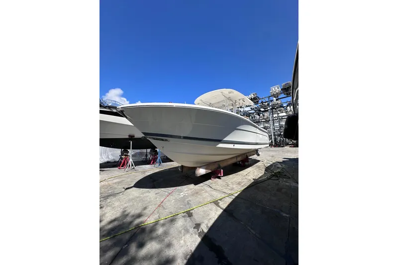 Slide: The Image of 2011 Robalo R300 Center Console boat on dry dock under clear blue sky. - 7