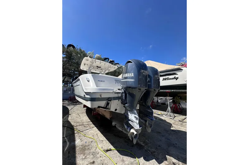 Slide: The Image of 2011 Robalo R300 Center Console boat with twin Yamaha 350 engines, docked outdoors. - 8