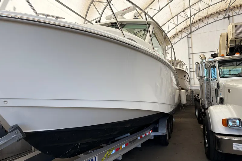 Slide: The Image of 2018 Boston Whaler 345 Conquest boat on trailer in storage facility. - 12
