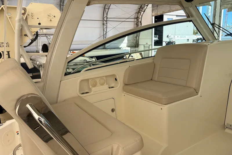 Slide: The Image of 2018 Boston Whaler 345 Conquest interior with beige seating and helm area. - 14