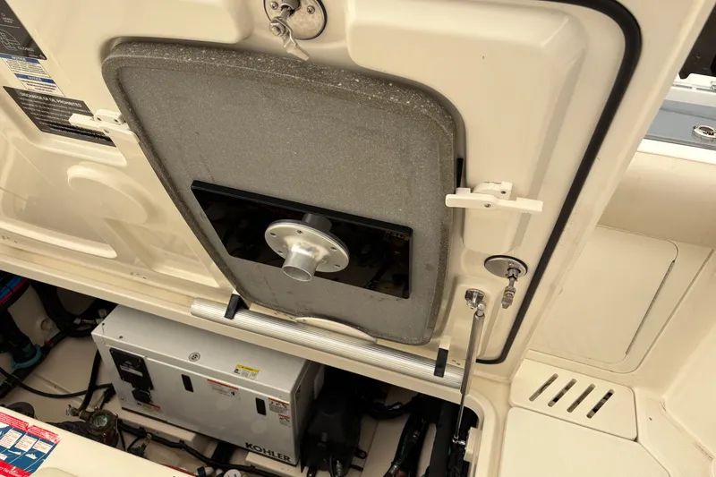 Slide: The Image of Engine compartment of a 2018 Boston Whaler 345 Conquest boat, featuring a Kohler generator. - 17