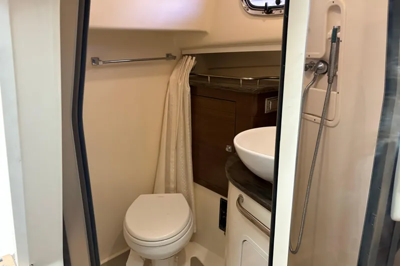 Slide: The Image of 2018 Boston Whaler 345 Conquest bathroom with toilet, sink, and showerhead. - 21