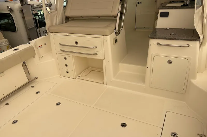 Slide: The Image of 2018 Boston Whaler 345 Conquest interior with seating, storage, and counter space. - 24