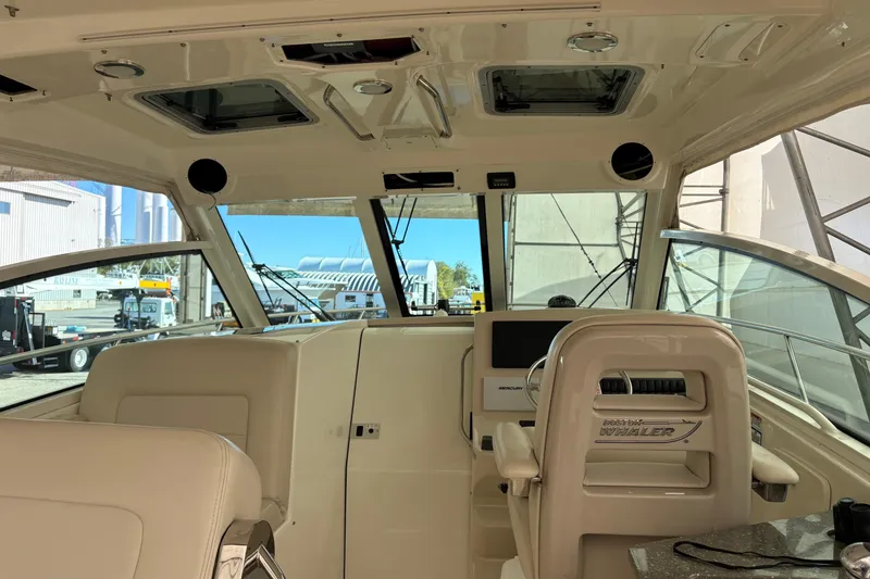 Slide: The Image of 2018 Boston Whaler 345 Conquest interior with helm and seating area. - 25