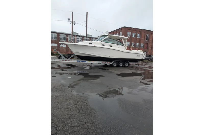 Slide: The Image of 2018 Boston Whaler 245 Conquest boat on trailer in industrial area. - 5