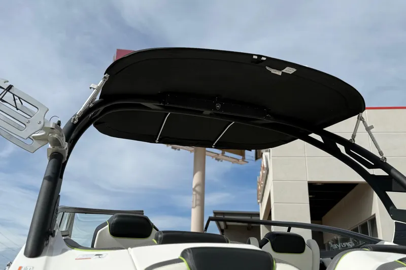 Slide: The Image of 2022 Yamaha Boats 212XD with black canopy and sleek design under blue sky. - 17