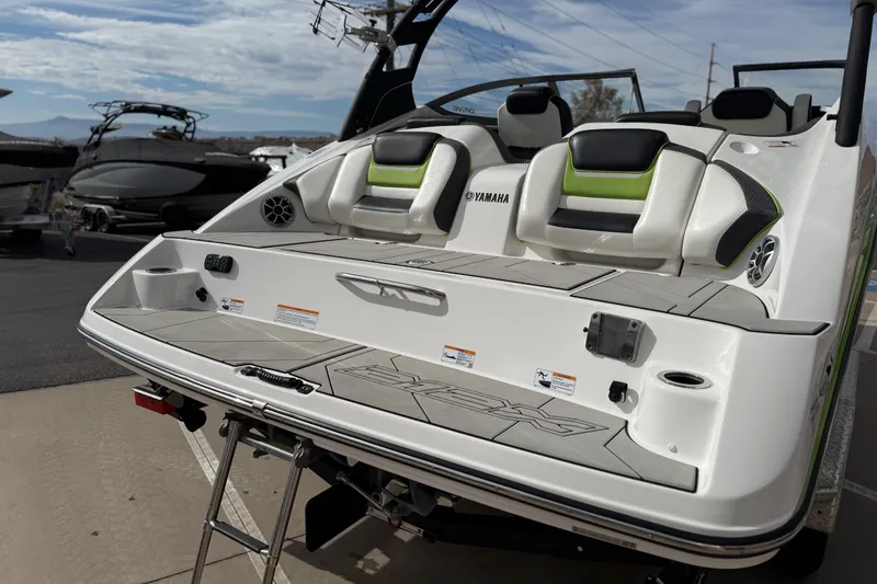 Slide: The Image of 2022 Yamaha Boats 212XD rear view with seating and swim platform. - 19