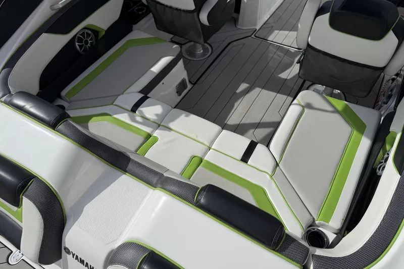 Slide: The Image of 2022 Yamaha Boats 212XD interior with green-accented seating and modern design. - 24