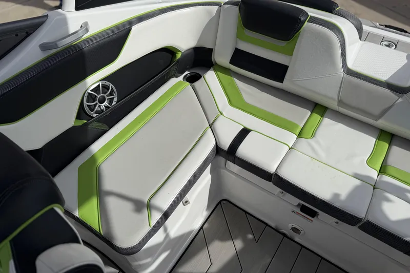 Slide: The Image of 2022 Yamaha Boats 212XD interior with green and white seating, speaker, and modern design. - 27