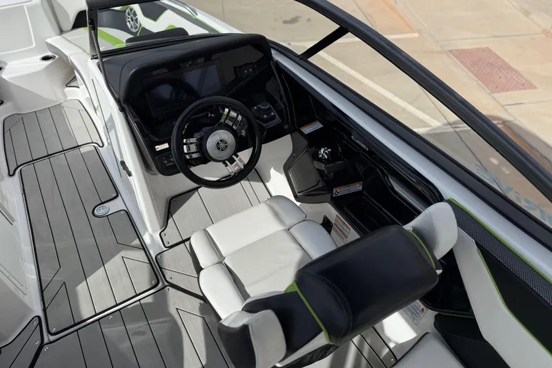 Slide: The Image of 2022 Yamaha Boats 212XD cockpit with steering wheel and seating, featuring modern design elements. - 32