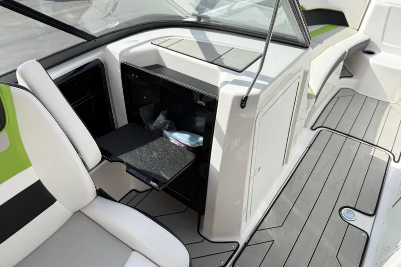 Slide: The Image of 2022 Yamaha Boats 212XD interior with open storage compartment and seating. - 33