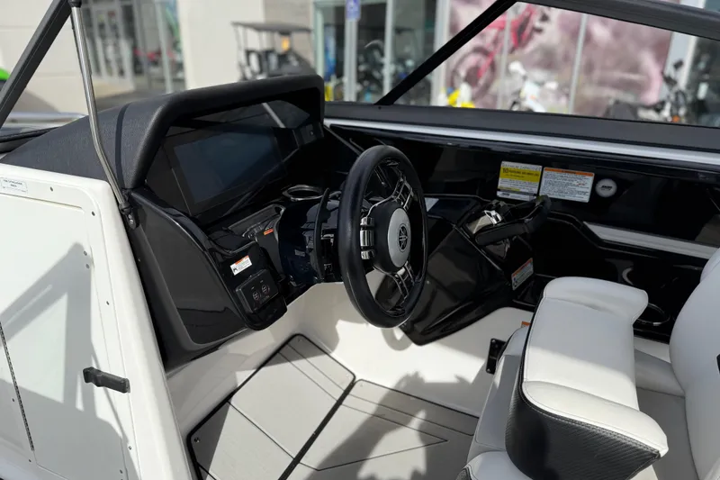 Slide: The Image of Interior view of 2022 Yamaha Boats 212XD, featuring sleek steering and modern dashboard. - 36