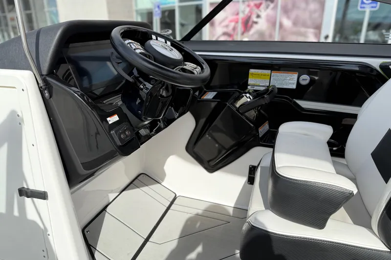 Slide: The Image of Interior of 2022 Yamaha Boats 212XD, featuring sleek steering and modern controls. - 37
