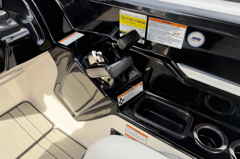 Slide: The Image of Control panel of 2022 Yamaha Boats 212XD, featuring throttle and warning labels. - 39