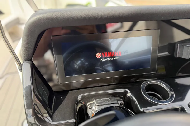 Slide: The Image of 2022 Yamaha Boats 212XD dashboard with digital display and cup holder. - 41