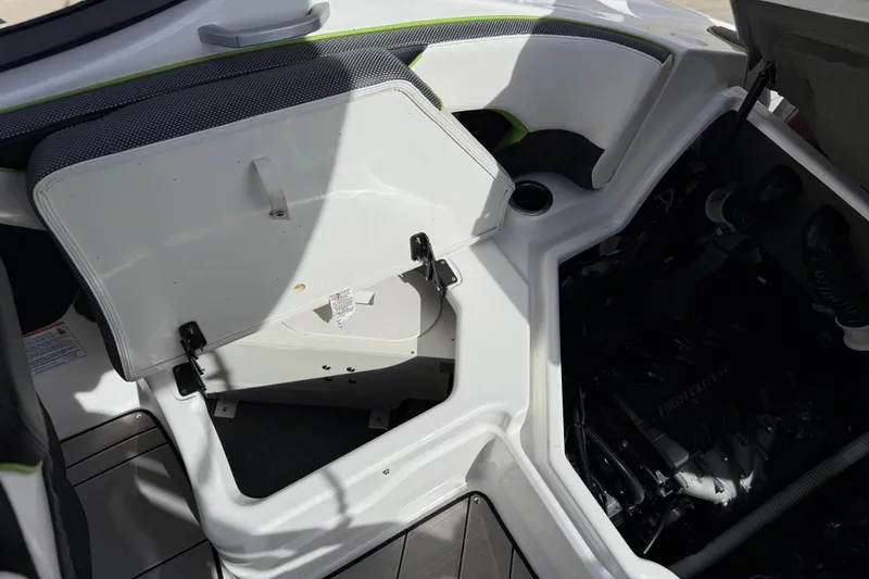 Slide: The Image of 2022 Yamaha Boats 212XD interior storage and engine compartment view. - 48