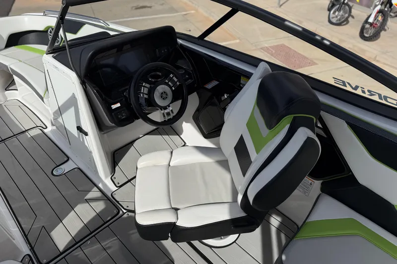 Slide: The Image of 2022 Yamaha Boats 212XD cockpit with steering wheel and modern seating design. - 49