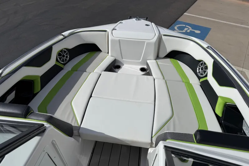 Slide: The Image of 2022 Yamaha Boats 212XD interior with green-accented seating and speakers. - 54