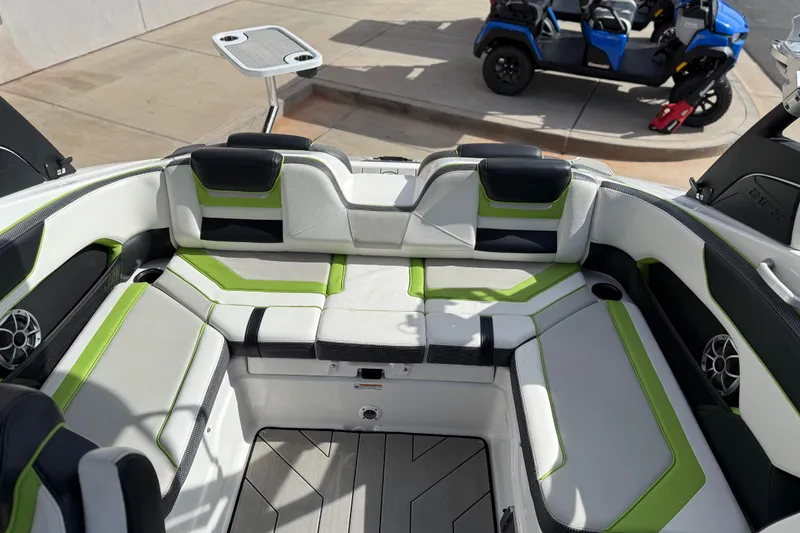 Slide: The Image of 2022 Yamaha Boats 212XD interior with green accents and seating area. - 58