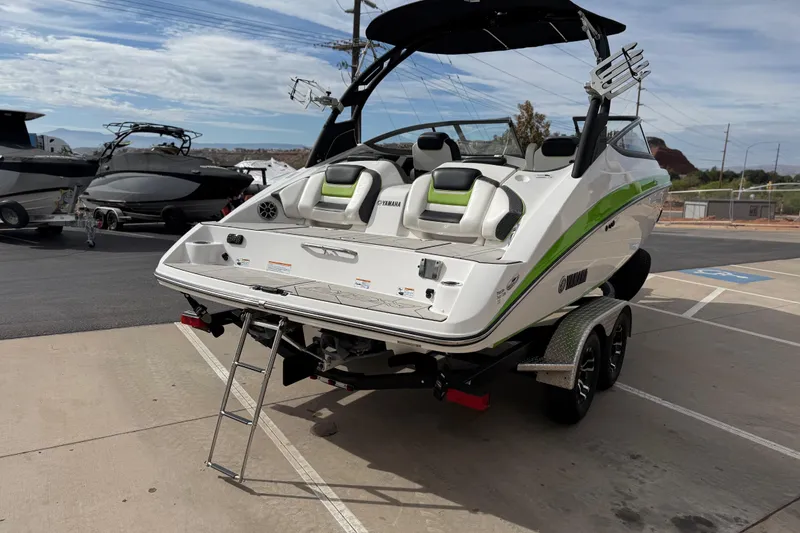Slide: The Image of 2022 Yamaha Boats 212XD on trailer, rear view with swim platform and ladder. - 6