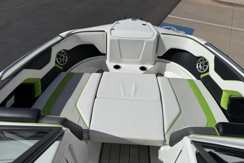 Slide: The Image of 2022 Yamaha Boats 212XD interior with green accents and modern seating design. - 60