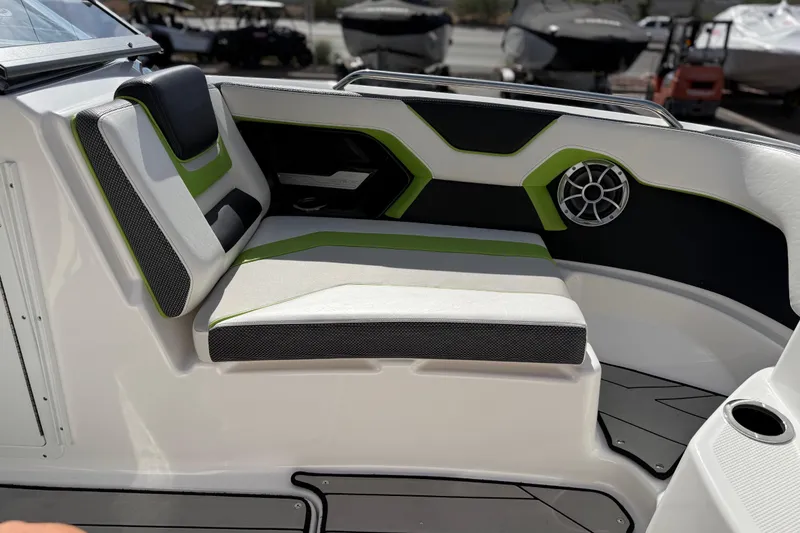 Slide: The Image of 2022 Yamaha Boats 212XD interior seating with green accents and speaker. - 63