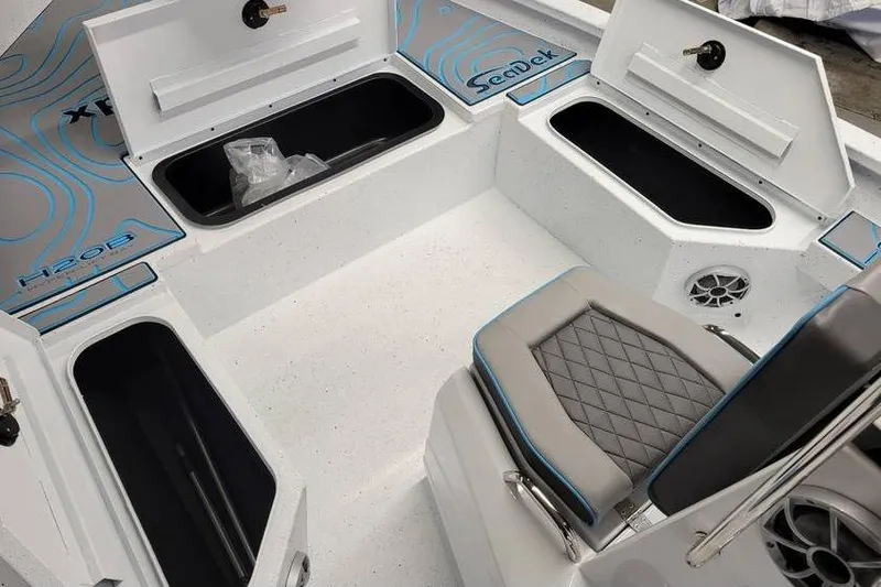 Slide: The Image of Interior of 2026 Xpress H20B Bay boat with storage compartments and seating. - 10