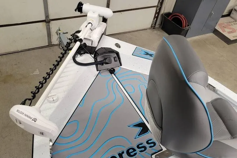 Slide: The Image of 2026 Xpress H20B Bay boat interior with Minn Kota trolling motor and seating. - 11