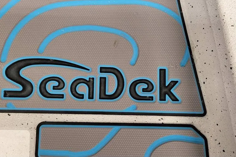 Slide: The Image of SeaDek logo on 2026 Xpress H20B Bay boat, featuring blue and gray design. - 14