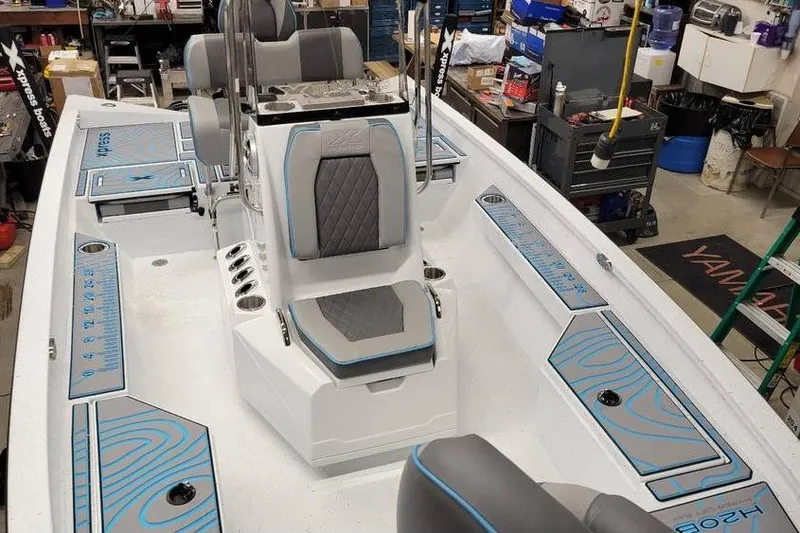 Slide: The Image of 2026 Xpress H20B Bay boat interior with modern seating and storage compartments. - 16