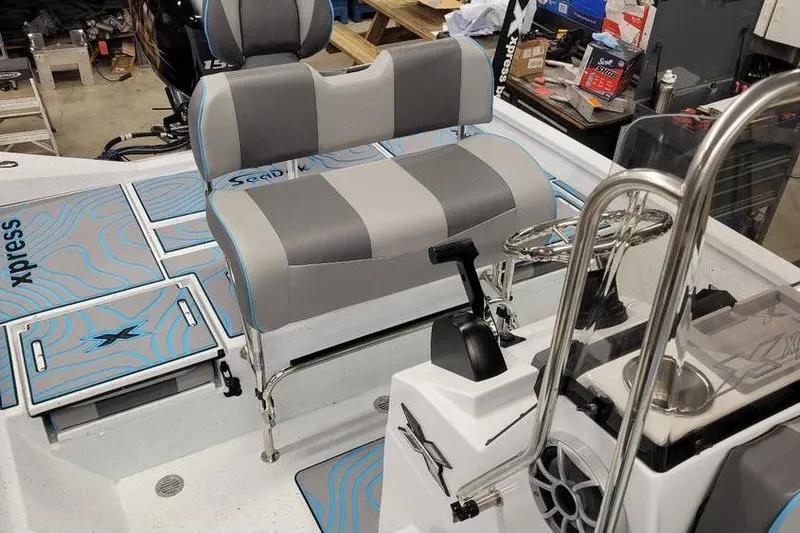 Slide: The Image of 2026 Xpress H20B Bay boat interior with gray seating and control console. - 20