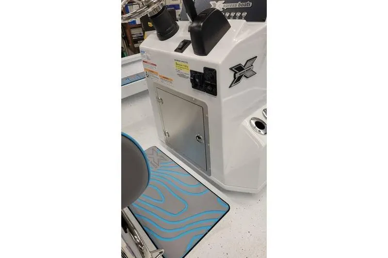 Slide: The Image of 2026 Xpress H20B Bay boat console with storage and steering wheel. - 23