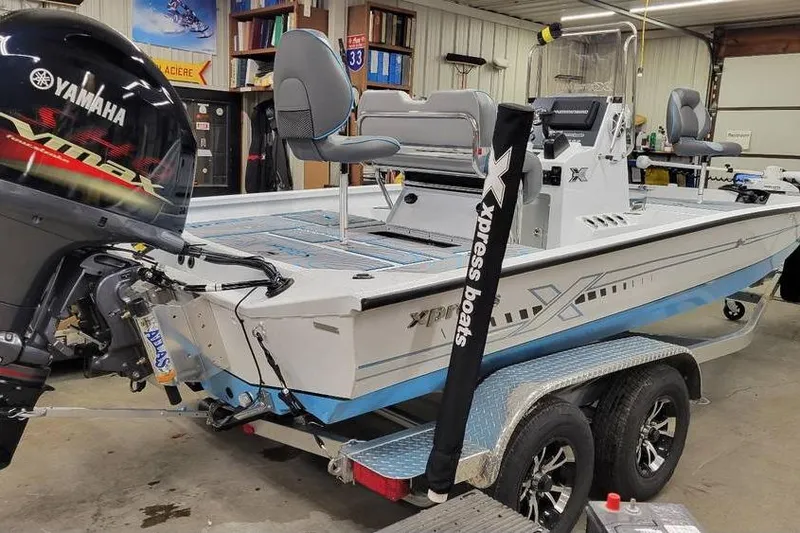 Slide: The Image of 2026 Xpress H20B Bay boat with Yamaha engine in a garage setting. - 5