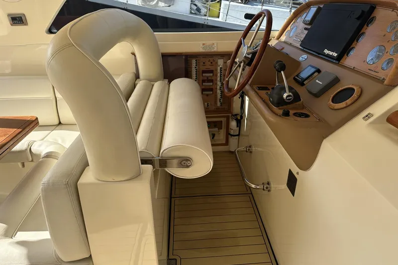 Slide: The Image of 2007 Mochi Craft 44 Dolphin yacht interior with steering wheel and control panel. - 12