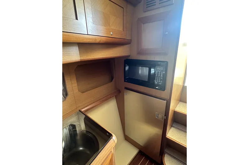 Slide: The Image of 2007 Mochi Craft 44 Dolphin yacht kitchen with microwave and compact fridge. - 17
