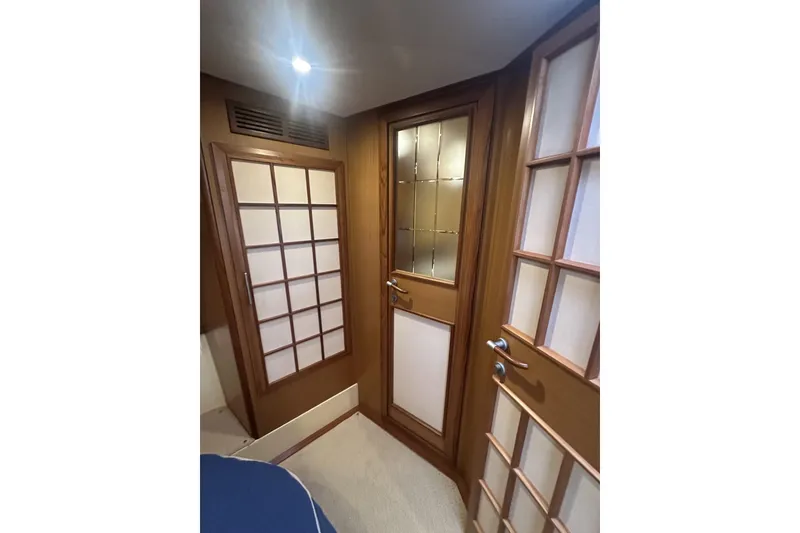 Slide: The Image of Interior of 2007 Mochi Craft 44 Dolphin yacht with wooden doors and soft lighting. - 20
