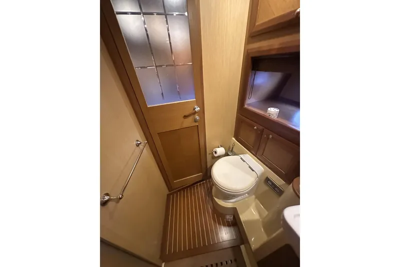 Slide: The Image of Luxurious bathroom in 2007 Mochi Craft 44 Dolphin yacht with wooden accents. - 22