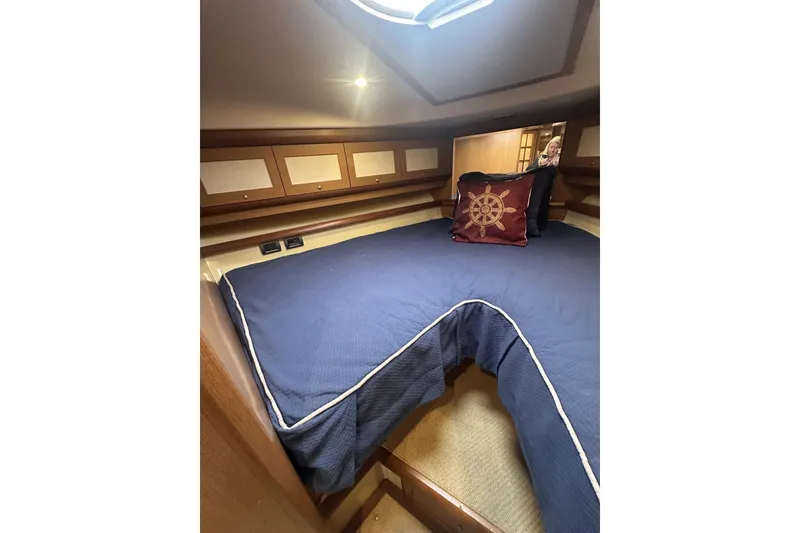 Slide: The Image of Luxurious cabin interior of 2007 Mochi Craft 44 Dolphin yacht with nautical-themed decor. - 24
